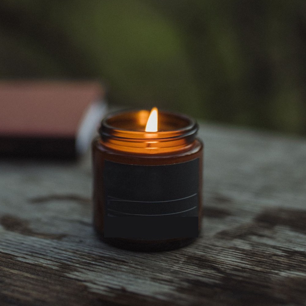 Cedar & Smoke candle in an amber glass jar